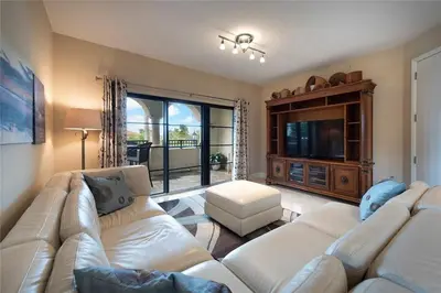 a living room with two white couches and a television at 2/2 Boutique Condo in Ft. Lauderdale in Fort Lauderdale