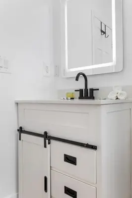 a kitchen with a sink and a white cabinet at Sun Getaway Rentals in Fort Lauderdale