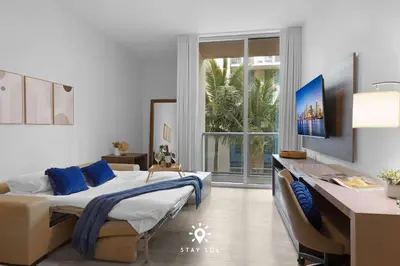 a bedroom with a bed and a desk and a window at Amazing Pool - Hot Tub - Hollywood Beach Haven in Hollywood