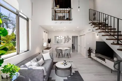 a living room with a couch and a table at Villa at St James Unit A Luxury Pool Villa, Pet Friendly in Miami