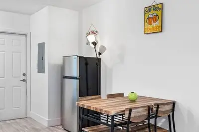 a kitchen with a table and a refrigerator in a room at Huge 1 bed newly renovated free parking in Miami