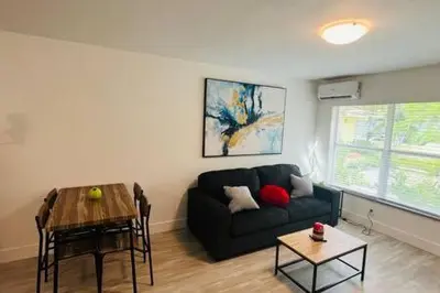 a living room with a couch and a table at Huge 1 bed newly renovated free parking in Miami
