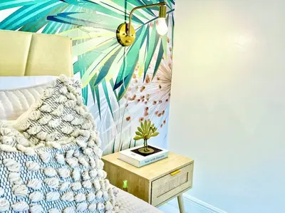 a bedroom with a bed with a plant on a night stand at Boho 6, studio Near Air-Cruise Port & Beach in Fort Lauderdale