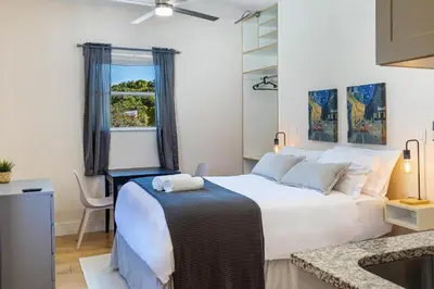 a bedroom with a large white bed and a window at Azure - Mins to Las Olas & Beach in Fort Lauderdale