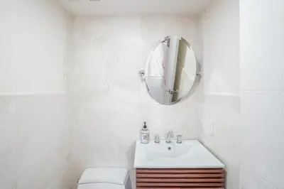 a white bathroom with a sink and a mirror at Luxury Pool Villa at St. James UNIT E, Pet Friendly in Miami
