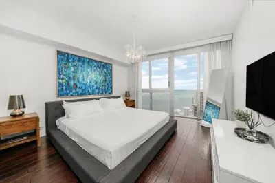a white bedroom with a bed and a large window at ICON W BRICKELL BY IMD MIAMI Marvelous Ocean View 2BR/2BA in Miami