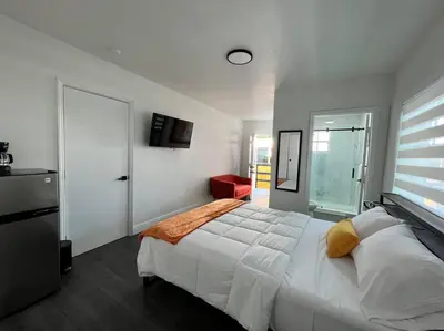 a bedroom with a large white bed and a window at Stylish 3/2 centrally located! in Miami