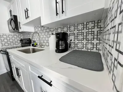 a kitchen with a sink and a counter top at Stylish 3/2 centrally located! in Miami