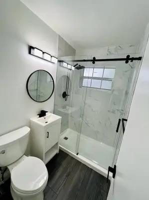 a white bathroom with a shower and a toilet at Stylish 3/2 centrally located! in Miami