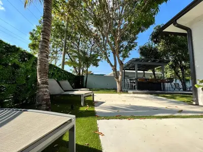 a backyard with a bench and a picnic table at Stylish 2/1 centrally located! in Miami