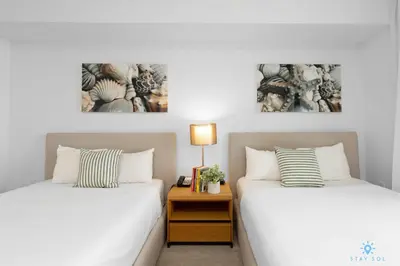 two beds sitting next to each other in a bedroom at Amazing view - Balcony - Gym - Pool in Hallandale Beach