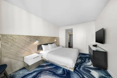a hotel room with a bed and a television at W FT LAUDERDALE RESIDENCES BY IMD MIAMI Stunning 2BR/2BA Unit in Fort Lauderdale