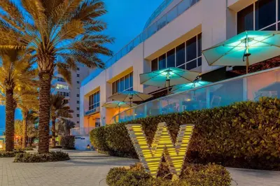 a hotel with a sign that says vwx in front of a building at W FT LAUDERDALE RESIDENCES BY IMD MIAMI Stunning 2BR/2BA Unit in Fort Lauderdale