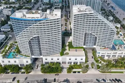 two tall buildings in a city next to the ocean at W FT LAUDERDALE RESIDENCES BY IMD MIAMI Stunning 2BR/2BA Unit in Fort Lauderdale