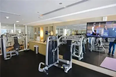 a gym with several tread machines and a flat screen tv at W FT LAUDERDALE RESIDENCES BY IMD MIAMI Stunning 2BR/2BA Unit in Fort Lauderdale