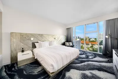 a bedroom with a large bed and a large window at W FT LAUDERDALE RESIDENCES BY IMD MIAMI Stunning 2BR/2BA Unit in Fort Lauderdale