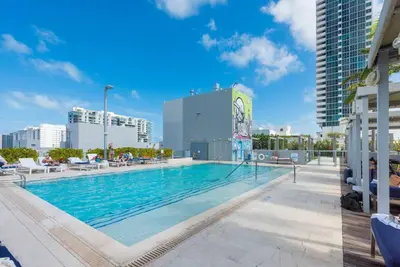 a swimming pool on the roof of a building at BOULAN HOTEL MIAMI BEACH BY IMD MIAMI 1BR/1BA UNIT in Miami Beach
