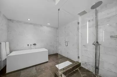 a white bathroom with a tub and a shower at BOULAN HOTEL MIAMI BEACH BY IMD MIAMI 1BR/1BA UNIT in Miami Beach
