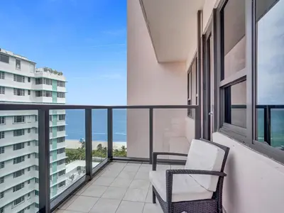 a balcony with a chair and a view of the ocean at Gorgeous Miami Beach Condo Beach Service 1614 in Miami Beach