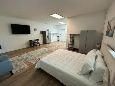 a bedroom with a large bed and a tv on the wall at Stylish StudioBrickellLittle Havana-ItalianPlaza in Miami