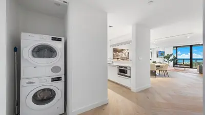 a white laundry room with a washer and dryer at 2B Ocean View Private Residence at South Beach - 804 in Miami Beach