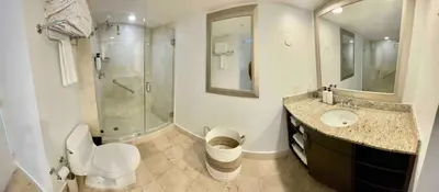 a bathroom with a shower and a toilet and a sink at Condo, Breathtaking Water views, King Suite, Hilton Property in Fort Lauderdale