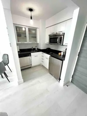 a kitchen with white cabinets and stainless steel appliances at Condo, Breathtaking Water views, King Suite, Hilton Property in Fort Lauderdale