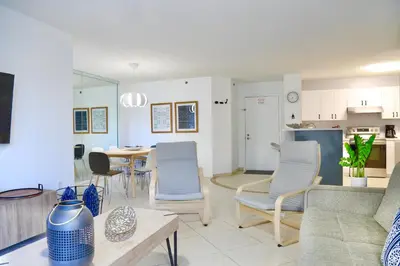 a living room with a couch and chairs and a table at Charming 2 bedroom 2 bathrooms at aventura in Miami