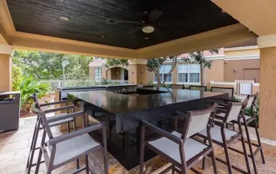 a large black table in a patio with chairs at Charming 2 bedroom 2 bathrooms at aventura in Miami