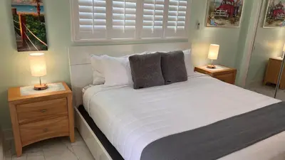 a bedroom with a large white bed with two night stands at Billy's Resort- Men Only - Solo Hombres in Wilton Manors