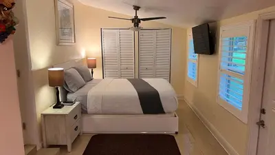 a bedroom with a bed and a ceiling fan at Billy's Resort- Men Only - Solo Hombres in Wilton Manors