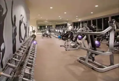 a gym with several treadmills and exercise machines at LOVELY 2 BR W ICON BRICKELL-WATERVIEWS -FREE SPA in Miami