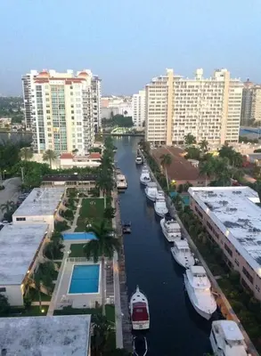 a group of boats docked in a river in a city at Fort Lauderdale Beach Resort by Vacatia in Fort Lauderdale
