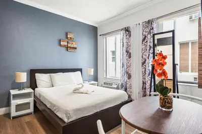 a small room with a bed and a table and a table sidx sidx at Lovely condo in Miami Beach in Miami Beach