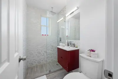 a bathroom with a shower and a toilet and a sink at Lovely condo in Miami Beach in Miami Beach