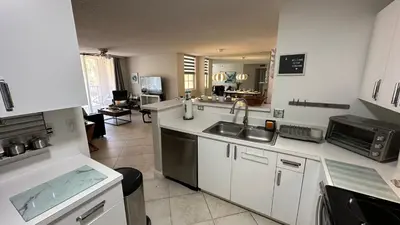 a kitchen with a sink and a counter top at Deluxe Yacht Club Condo Near the Beach in Miami