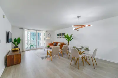 a living room with a table and chairs and a couch at Condo with Panoramic City Views in Brickell in Miami