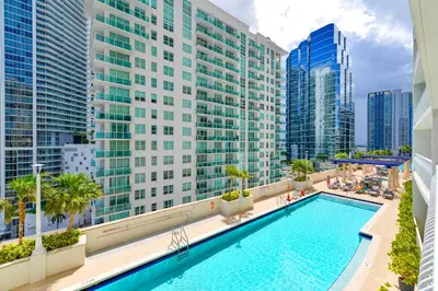 a pool on the balcony of a building with tall buildings at Condo with Panoramic City Views in Brickell in Miami