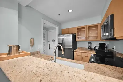 a kitchen with a granite counter top and stainless steel appliances at Stylish Suite to Have a Great Stay! in Miami