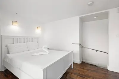 a white bedroom with a white bed and a closet at Ocean Drive Apartment Suites in Miami Beach in Miami Beach