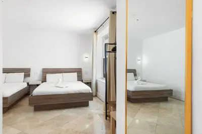a bedroom with two beds and a mirror at Ocean Drive Apartment Suites in Miami Beach in Miami Beach