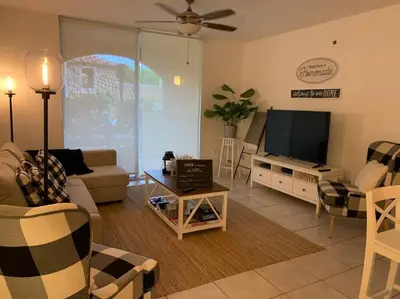 a living room with a couch and a television at Pet-Friendly Aventura Pool, Beach, Golf, Gym in Aventura