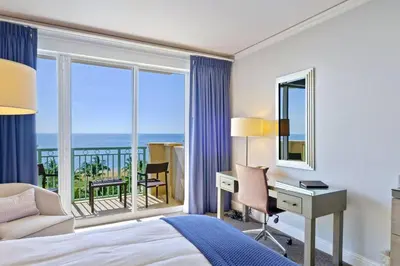a hotel room with a bed and a desk and a window at Leave the Worries Behind & Relax in Our Suite! in Miami