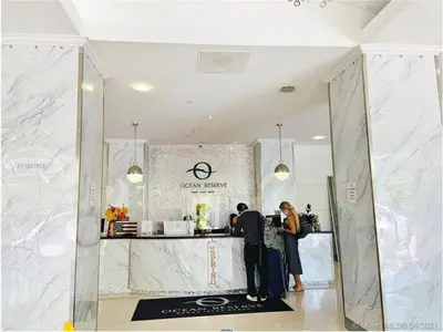 two people standing at a counter in a store at Condominium Sunny Isles Ocean Reserve in Sunny Isles Beach