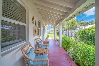 a porch with two chairs and a window at Bluewave Bungalow - #1 Charming & Comfortable 2 1 in Dania Beach