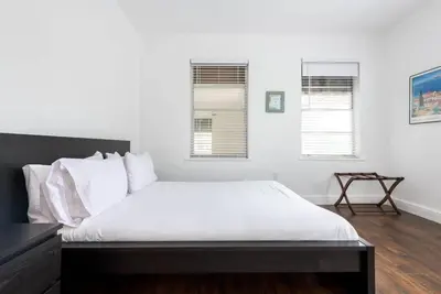 a bedroom with a bed with white sheets and two windows at Casa Havana Renovated 3 2-Near Brickell&Downtown in Miami