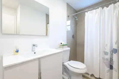 a white bathroom with a toilet and a sink at Casa Havana Renovated 3 2-Near Brickell&Downtown in Miami