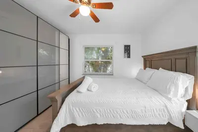 a bedroom with a bed with a ceiling fan at Renovated Gem: Prime Spotless Ideal in Miami