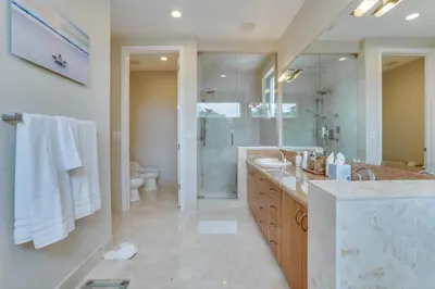a bathroom with a shower and a sink and a toilet at 4-Bed + Den with pool in Las Olas Ft Lauderdale in Fort Lauderdale