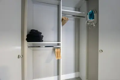 a white cabinet with a mirror in a room at Sunshine Manor 2009 in Fort Lauderdale